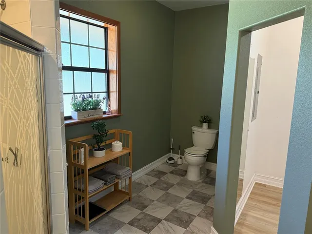 a bedroom with a bed and a chair