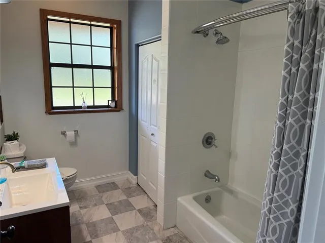 a bedroom with a bed and painting on the wall