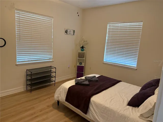 a bedroom with a bed and a window