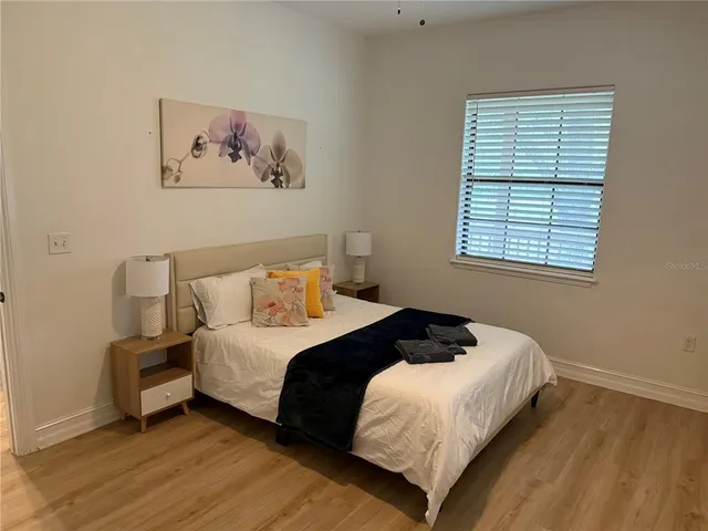 a view of a house with pool and wooden floor