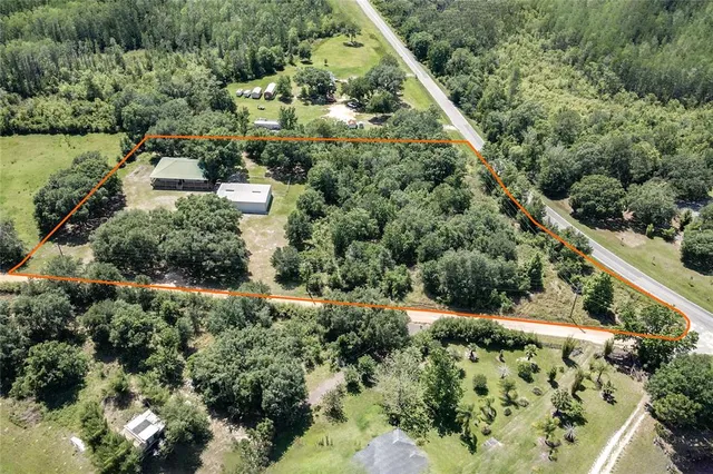 an aerial view of residential houses with outdoor space and street view