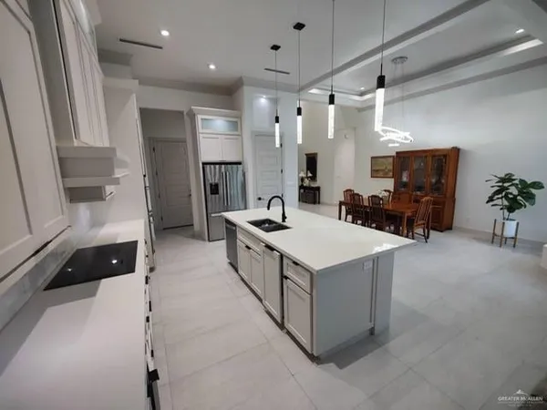 a large bathroom with a sink a large mirror and a shower