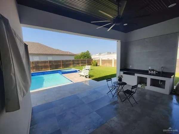 a view of a chairs and table in patio with a tv