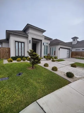 a view of a house with a garden and plants