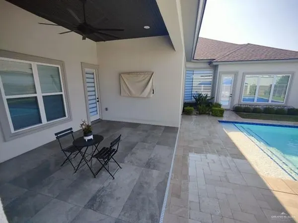 a view of a house with backyard and sitting area