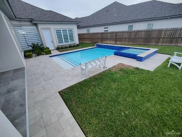 a view of backyard with swimming pool and porch