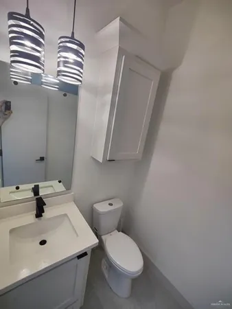 a bathroom with a sink a toilet and mirror