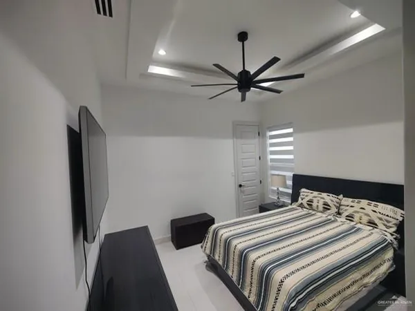 a bedroom with a bed and a chandelier