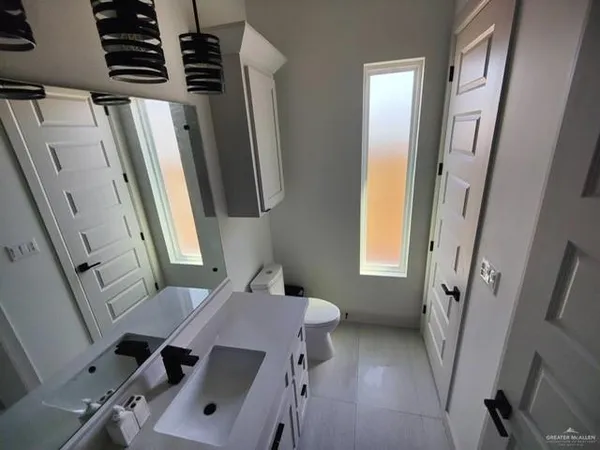 a bathroom with a sink a mirror and a toilet