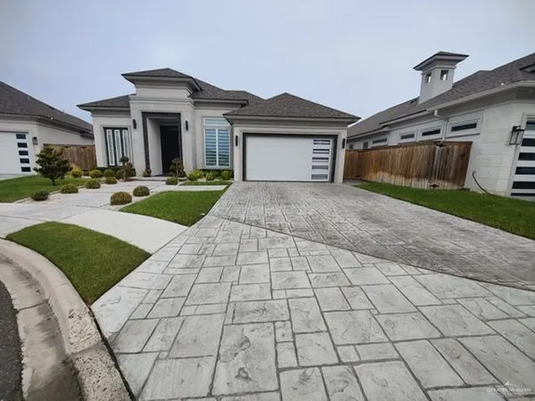a front view of a house with yard and garage