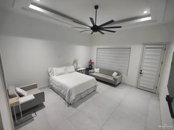 a bedroom with a bed and a ceiling fan