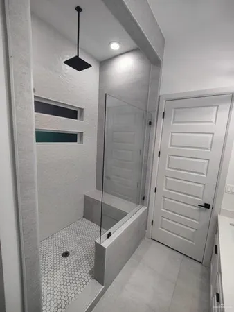 a bathroom with a shower and a sink