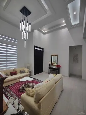 a bedroom with a bed and chandelier