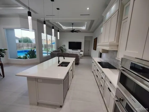 a kitchen with stainless steel appliances a stove a sink and a microwave