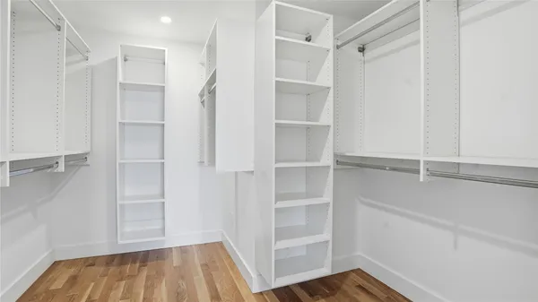a view of walk in closet with empty racks