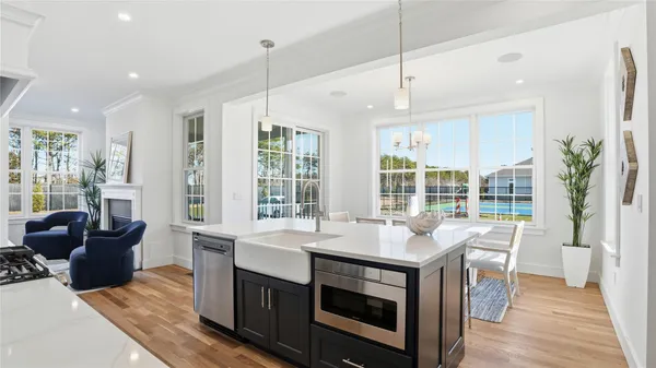 a open kitchen with stainless steel appliances granite countertop a stove a sink and a refrigerator