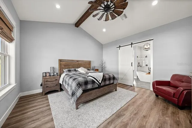 a large white bathroom with a double vanity sink a mirror and a bathtub