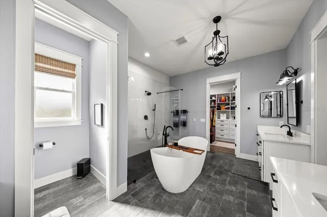 a kitchen with a sink and wooden floor