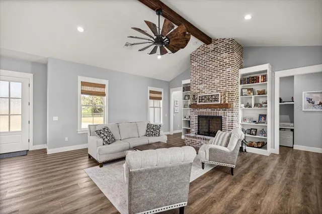 a living room with furniture fireplace and window