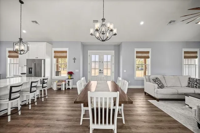 a living room with furniture chandelier and a table