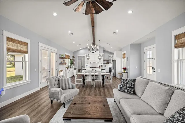 a living room with furniture and a chandelier