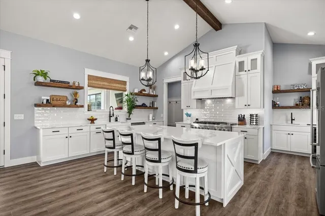 a large kitchen with a table and chairs