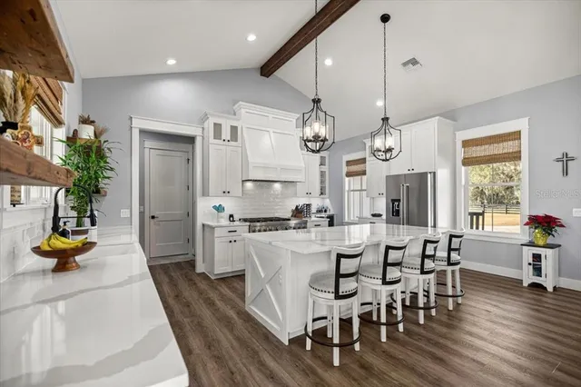 a large kitchen with a table and chairs