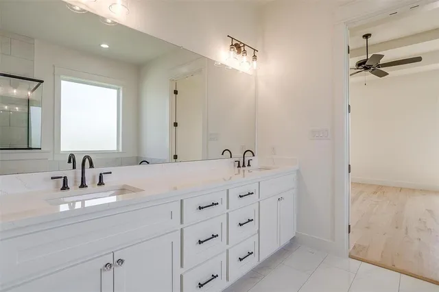 a bathroom with double vanity sinks and a mirror