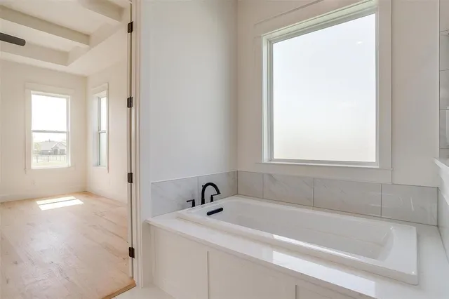 a white bath tub sitting next to a window