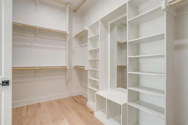 a view of walk in closet with empty racks
