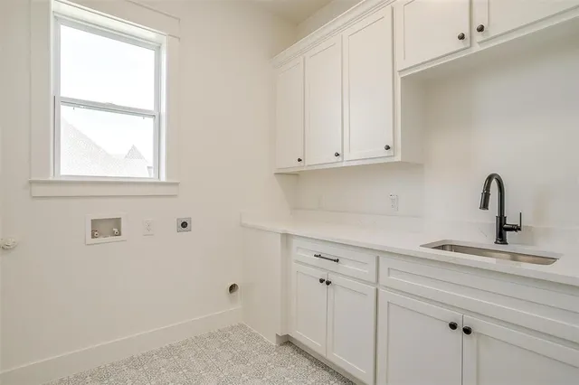 a kitchen with white cabinets and a sink