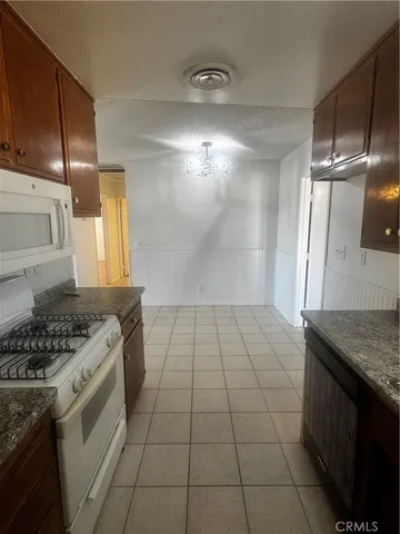 a kitchen with a stove a sink and a refrigerator