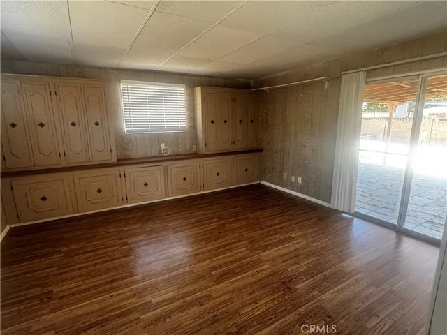a view of a room with wooden floors and cabinet