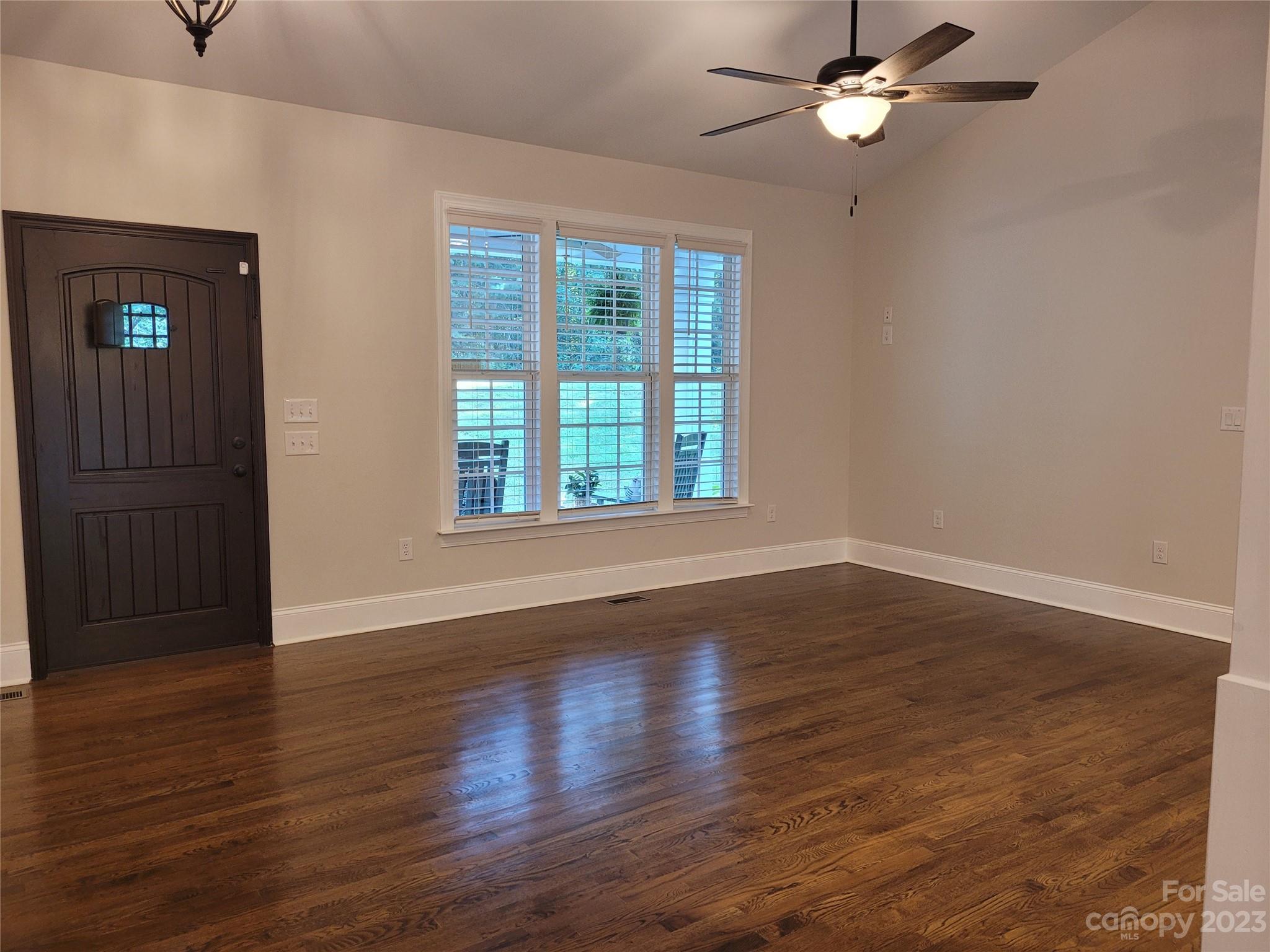 2775 Beechwood Road Denver, NC 28037 - Photo 11 of 26 a view of an empty room with wooden floor and a window
