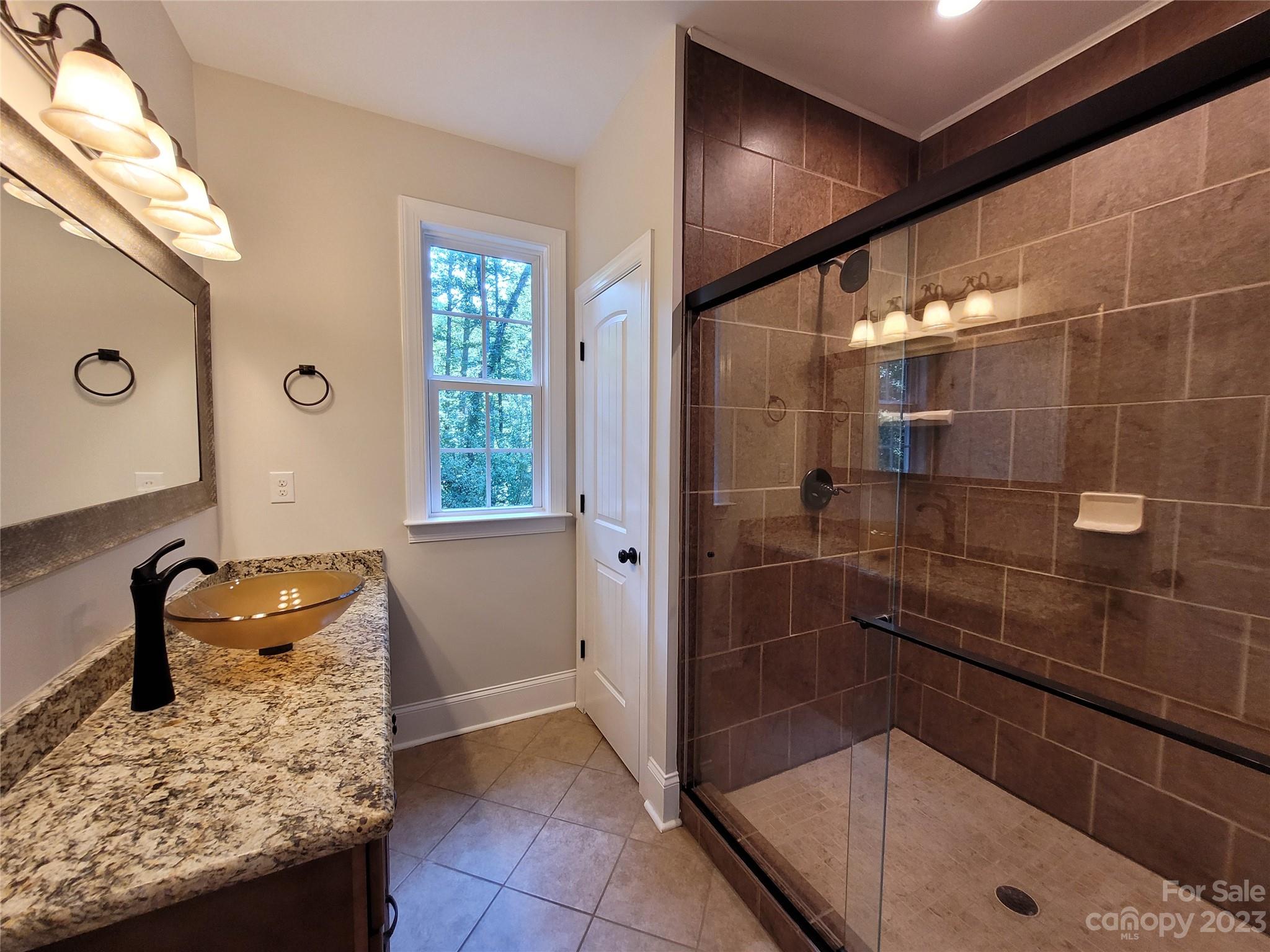 2775 Beechwood Road Denver, NC 28037 - Photo 17 of 26 a bathroom with a granite countertop sink a toilet and mirror