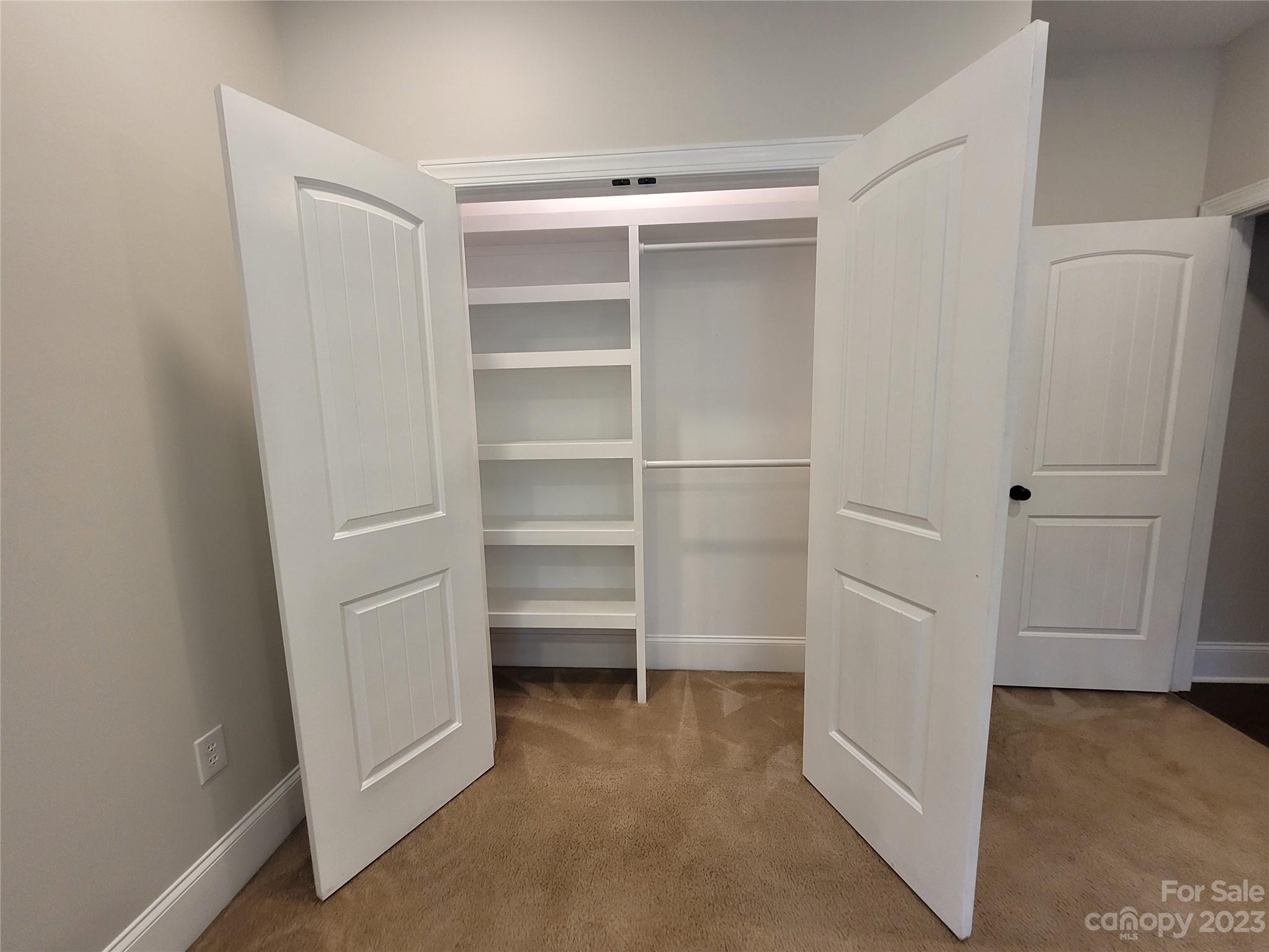 2775 Beechwood Road Denver, NC 28037 - Photo 18 of 26 a view of walk in closet with empty racks