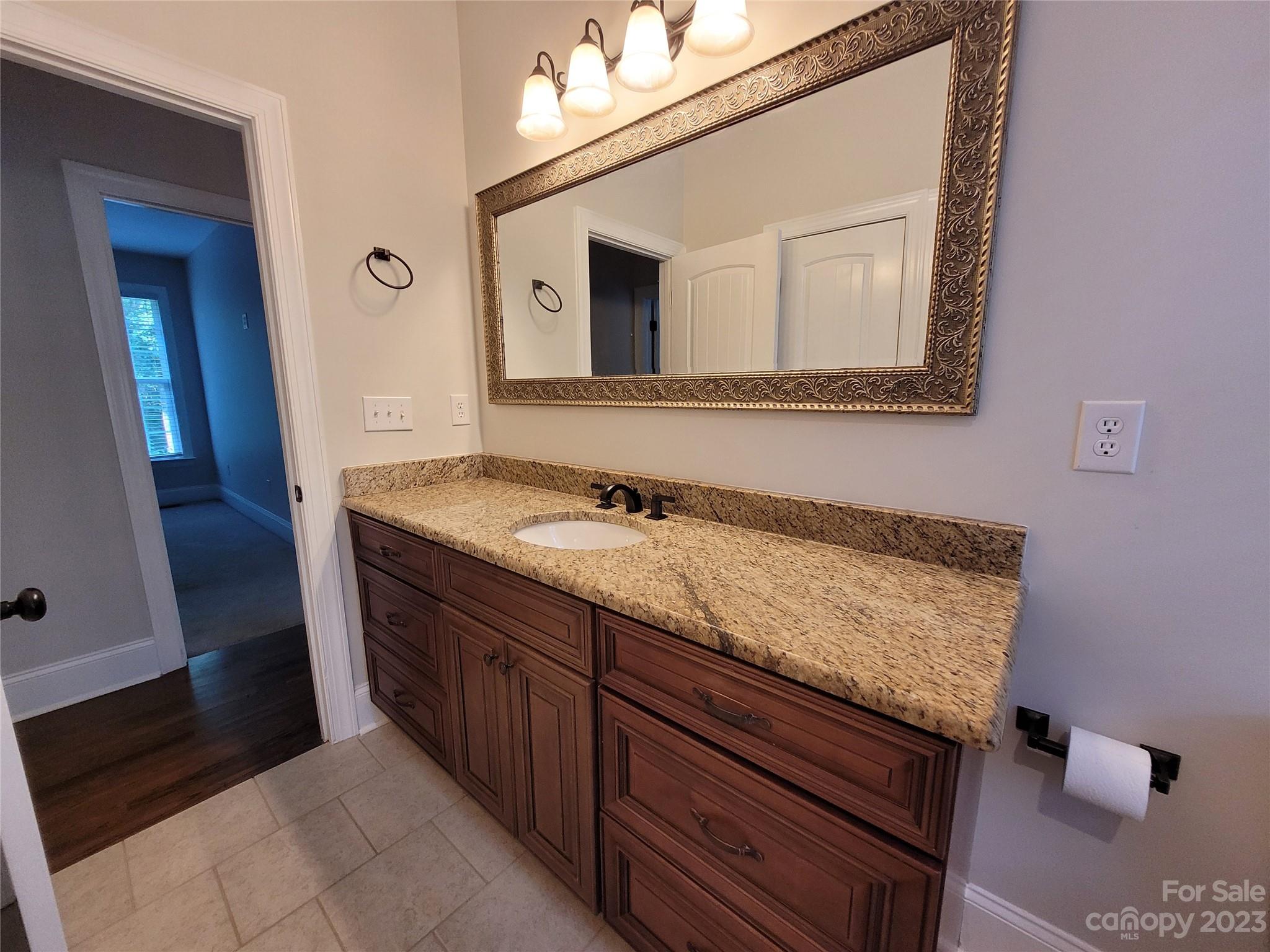2775 Beechwood Road Denver, NC 28037 - Photo 26 of 26 a bathroom with a granite countertop sink and a mirror