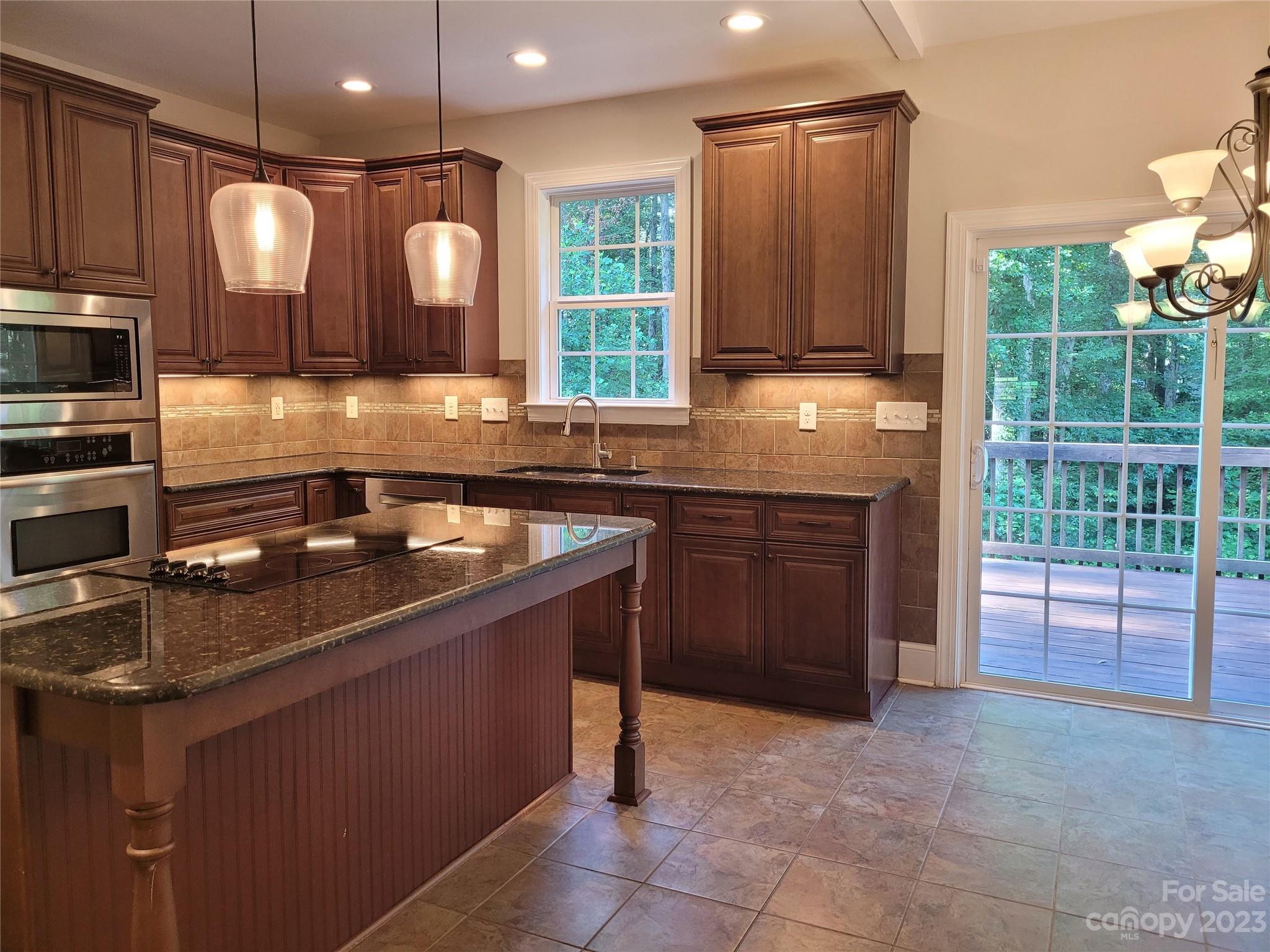 2775 Beechwood Road Denver, NC 28037 - Photo 9 of 26 a kitchen with a sink cabinets and window