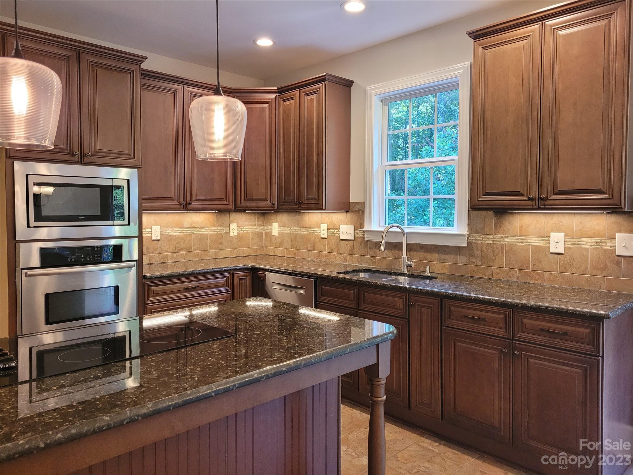 2775 Beechwood Road Denver, NC 28037 - Photo 10 of 26 a kitchen with a sink a microwave a stove and cabinets