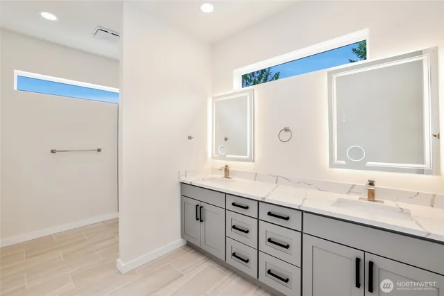 a bathroom with a double vanity sink and a mirror