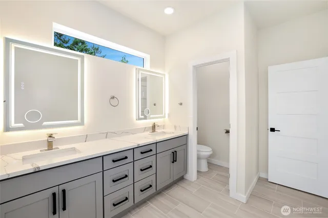 a bathroom with a double vanity sink and a mirror