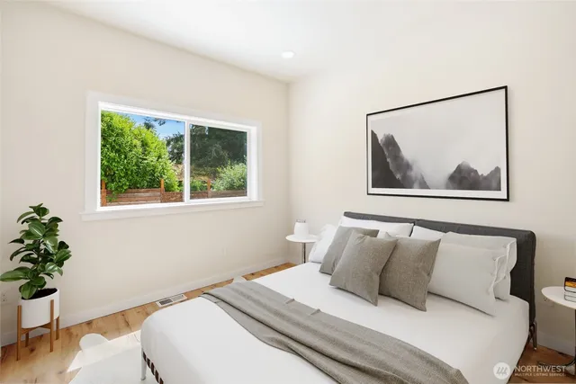 a bedroom with bed and a potted plant