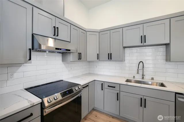 a kitchen with cabinets a sink and a stove