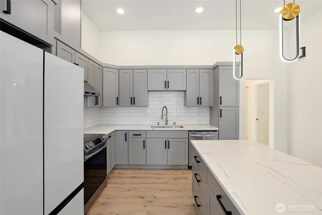 a kitchen with a sink a refrigerator and a stove
