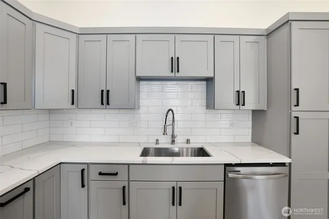 a kitchen with a sink cabinets and stainless steel appliances