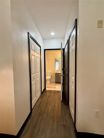 a view of hallway with wooden floor