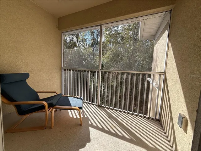 a view of a chair and table in the balcony