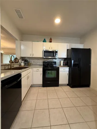 a kitchen with a stove a sink and a refrigerator