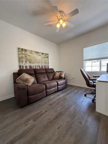 a living room with furniture a chandelier and a window
