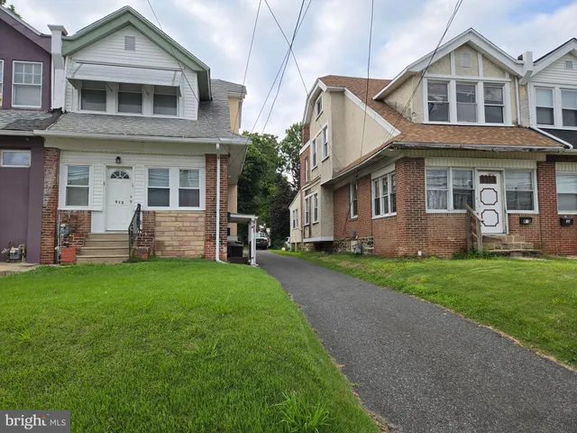 a front view of a house with a yard and porch